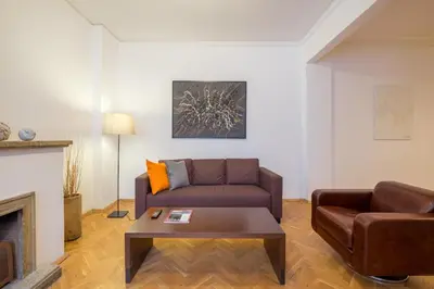 a living room with a couch and a coffee table at THE GOOD PLACE - historical center, unique in Sofia