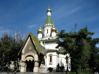 a building with a steeple with gold domes on it at THE GOOD PLACE - historical center, unique in Sofia