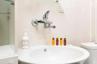 a bathroom with a sink and a toilet at HeBrOs Park Apartment Next to Kapana 2BR in Plovdiv