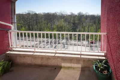 a balcony with a white railing and a view of a street at 2BDR Yavorov apartment in Sofia