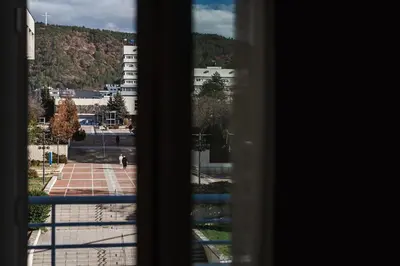 a view of a city from a window at Уютно студио Verde Suites 14 in Blagoevgrad