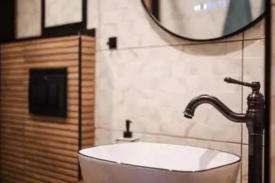 a bathroom with a white sink and a mirror at Уютно студио Verde Suites 14 in Blagoevgrad