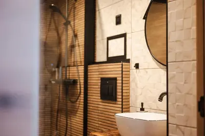a bathroom with a toilet and a sink and a mirror at Уютно студио Verde Suites 14 in Blagoevgrad