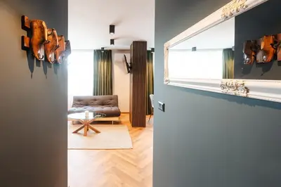 a living room with a couch and a chair at Уютно студио Verde Suites 14 in Blagoevgrad
