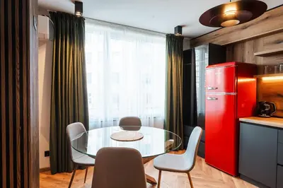 a kitchen with a glass table and a red refrigerator at Уютно студио Verde Suites 14 in Blagoevgrad