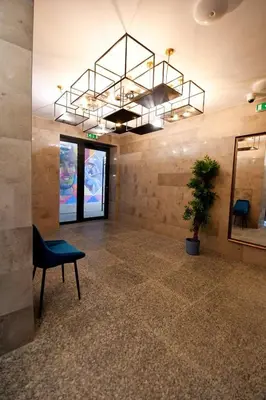 a lobby with a chair and a chandelier at MD Your Fancy Place in Sofia