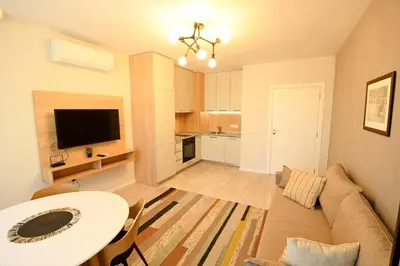 a living room with a couch and a table and a television at MD Your Fancy Place in Sofia