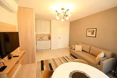 a living room with a couch and a kitchen at MD Your Fancy Place in Sofia