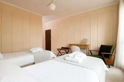 a room with two beds and a table and chairs at 21 Villa Vitosha Hills View in Hisarya