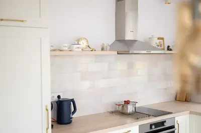 a kitchen with a stove with a pot on the counter at 21 Villa Vitosha Hills View in Hisarya