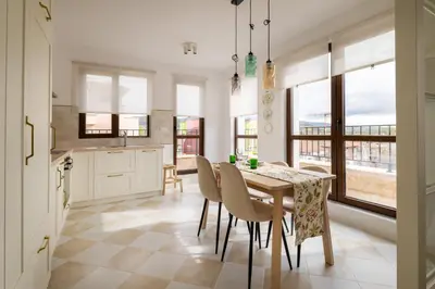 a kitchen and dining room with a table and chairs at 21 Villa Vitosha Hills View in Hisarya