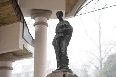a statue of a woman standing next to a building at 21 Villa Vitosha Hills View in Hisarya