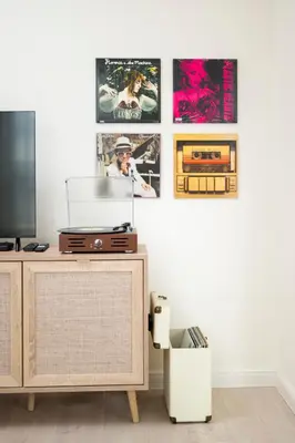 a living room with a tv and pictures on the wall at 21 Villa Vitosha Hills View in Hisarya