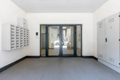 an empty hallway with a glass door in a building at Smart Studio in the heart of Sofia in Sofia