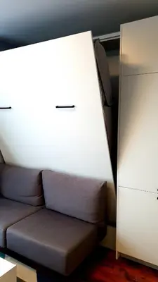a living room with a couch and a white cabinet at Smart Studio in the heart of Sofia in Sofia
