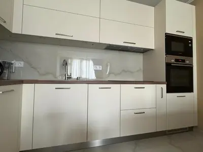 a white kitchen with white cabinets and a microwave at ApartmentSpiceDevin in Devin