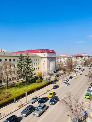 a busy city street filled with lots of cars at Slavveykovs Apartment in Sofia