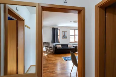 an open door to a living room with a couch at 'Chamonix' in Bansko - 1 bedroom - SKI IN&OUT - Free spa in Bansko
