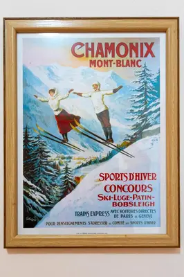 a framed poster of two people skiing on a mountain at 'Chamonix' in Bansko - 1 bedroom - SKI IN&OUT - Free spa in Bansko