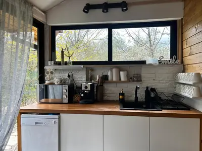 a kitchen with a counter top and a window at VILLA INBAR - Village house on the river in Boykovets