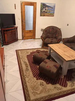 a living room with a couch and a table at Къща Томови in Devin