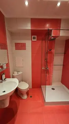 a bathroom with a shower and a toilet and a sink at Central Springs Apartment in Sofia