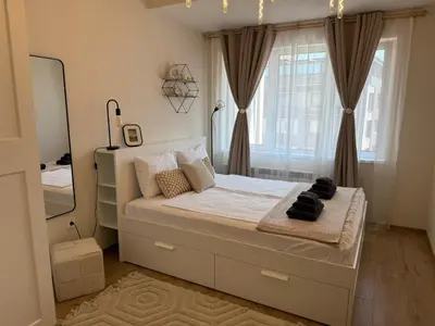 a bedroom with a large bed with a large window at Koko's Cozy Apartment - free Garage Netflix and Balcony in Sofia