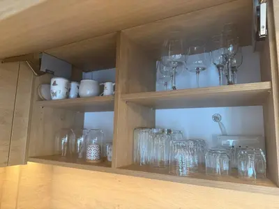 a cabinet filled with glass jars and wine glasses at Koko's Cozy Apartment - free Garage Netflix and Balcony in Sofia