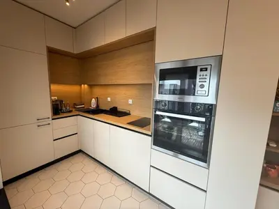 a kitchen with white cabinets and a microwave at Koko's Cozy Apartment - free Garage Netflix and Balcony in Sofia