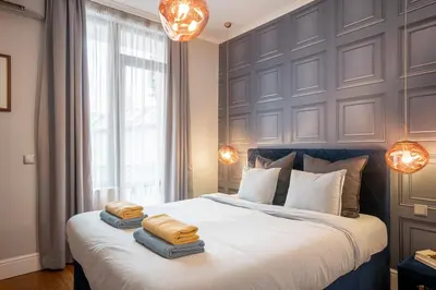 a bedroom with a large bed with two towels on it at Landmark Luxe 2BR Apt with Parking in Sofia