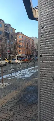 a brick wall next to a street with cars at Urban Comfort - Central 1BDR near Vitoshka & NDK by Flat Mаnager in Sofia