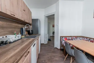 a kitchen with a wooden counter top and a table at Vitoshka Inn in Sofia