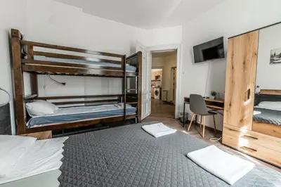 a bedroom with two bunk beds and a desk at Vitoshka Inn in Sofia