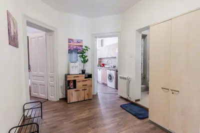a kitchen with white walls and a wooden floor at Vitoshka Inn in Sofia
