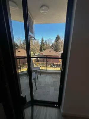 a door to a balcony with a view of a patio at Apartment Aria 4 in Velingrad