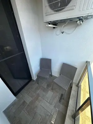 two benches sitting in a room with a fan at Apartment Aria 4 in Velingrad