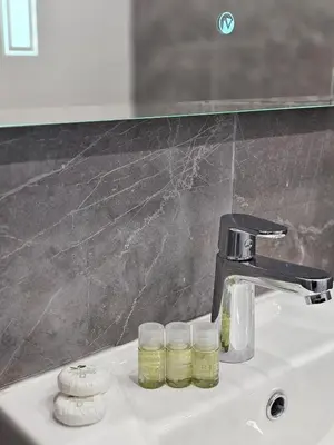 a bathroom sink with two jars and a faucet at Continental studios 1 in Sofia
