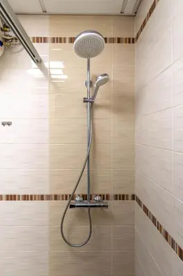 a shower with a shower head in a bathroom at Apart Center Nikola in Plovdiv