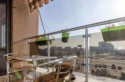 a balcony with a table and chairs and a view of a city at Apart Center Nikola in Plovdiv