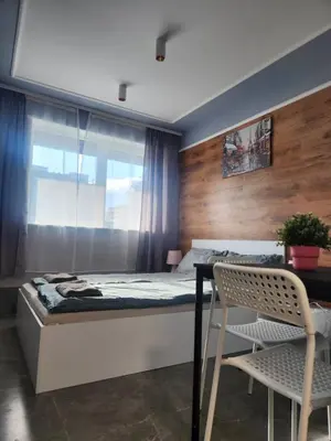 a bedroom with a bed and a table and a chair at Continental studios 5 in Sofia