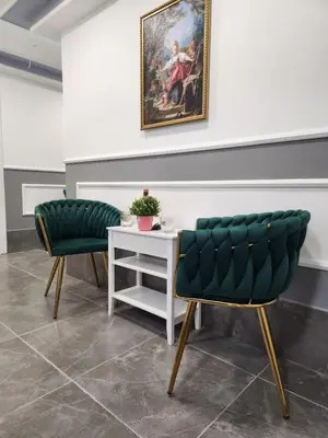 two green chairs and a table in a room at Continental studios 5 in Sofia