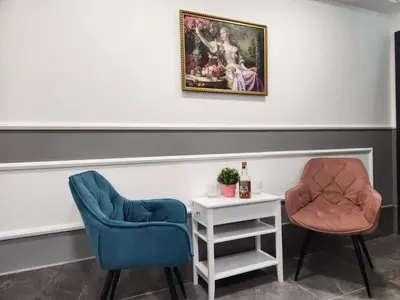 two chairs and a table with a bottle of wine at Continental studios 5 in Sofia