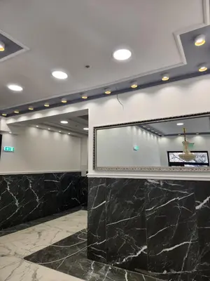 a meeting room with a projection screen and marble floors at Continental studios 3 in Sofia
