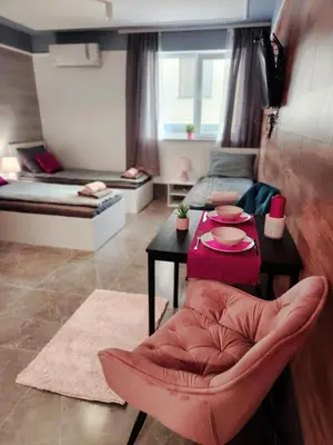a living room with a table and a couch at Continental studios 3 in Sofia