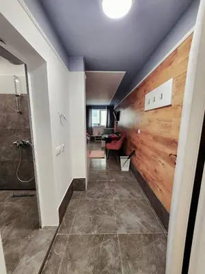 a hallway of a home with a wooden wall at Continental studios 3 in Sofia