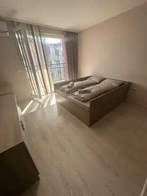 a bedroom with a bed and a large window at Good Morning in Sofia