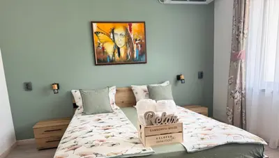 a bedroom with a bed with a box on it at Kamberovi house Kalofer Къща Камберови Калофер in Kalofer