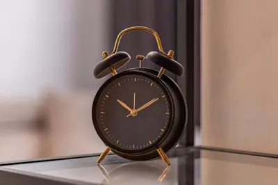 a black clock sitting on top of a table at Grand Suborna Retreat in Sofia