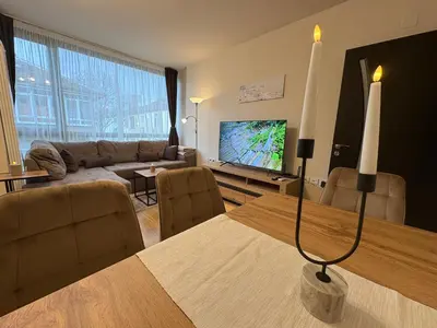 a living room with a couch and a table with a television at Apart-Tundzha 6 in Sofia