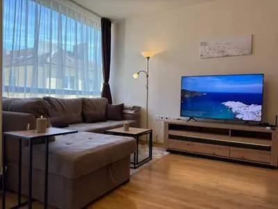 a living room with a couch and a flat screen tv at Apart-Tundzha 6 in Sofia